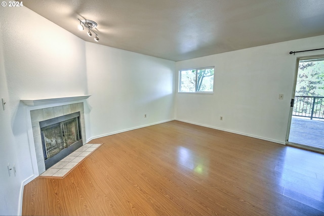 unfurnished living room featuring hardwood / wood-style flooring and a fireplace