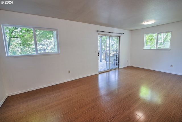 unfurnished room with wood-type flooring