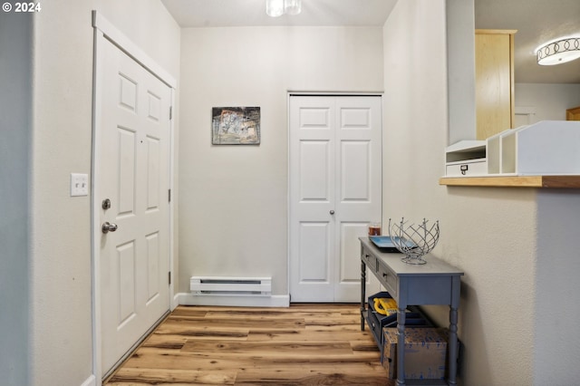 entryway featuring a baseboard radiator and light hardwood / wood-style floors