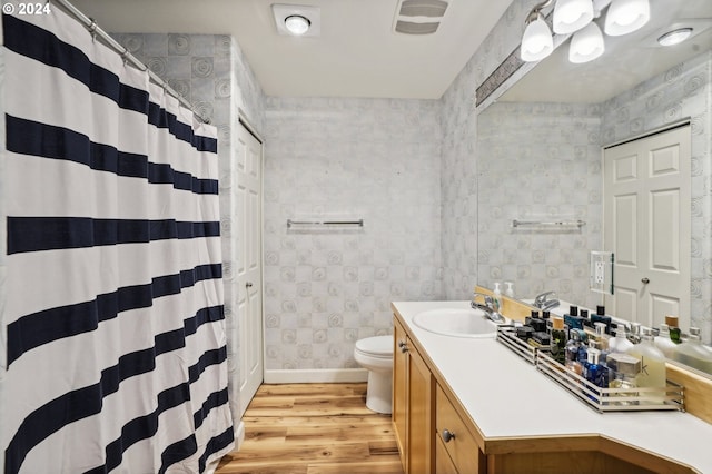 bathroom with vanity, hardwood / wood-style flooring, and toilet