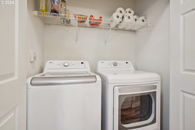 washroom with washing machine and clothes dryer