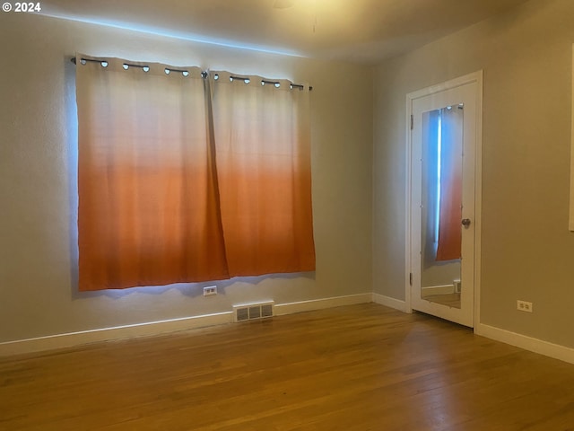 unfurnished room featuring hardwood / wood-style floors