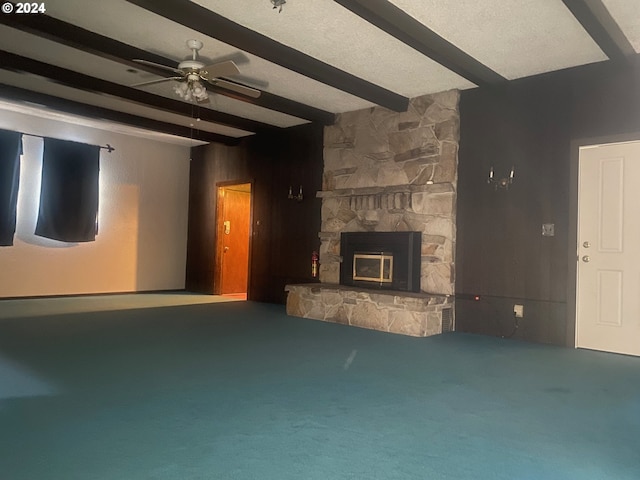 unfurnished living room with carpet, a fireplace, and beam ceiling