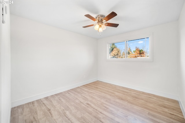 spare room with ceiling fan and light wood-type flooring