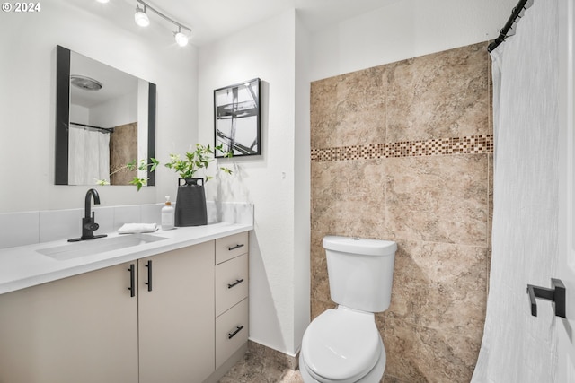 bathroom with toilet and vanity