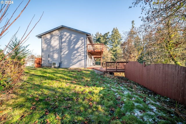 back of house with a balcony and a lawn