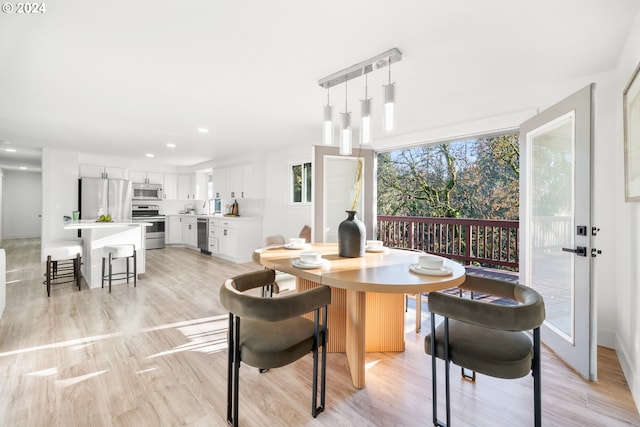 dining room featuring light hardwood / wood-style floors and wine cooler