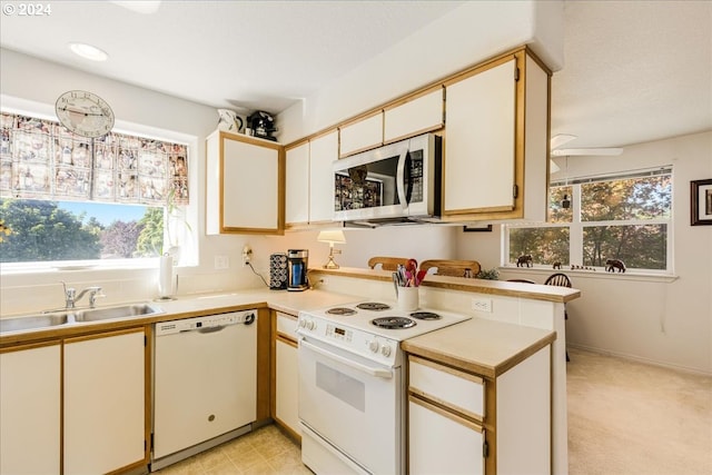 4744 W Powell Blvd Unit K227, Gresham, OR 97030 - kitchen featuring light countertops, white appliances, plenty of natural light, and a sink