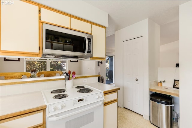 4744 W Powell Blvd Unit K227, Gresham, OR 97030 - kitchen with stainless steel microwave, electric stove, and light countertops