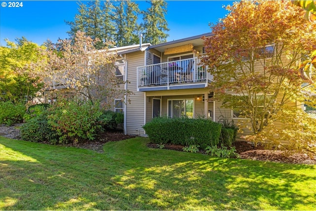 4744 W Powell Blvd Unit K227, Gresham, OR 97030 - rear view of property with a lawn and a balcony