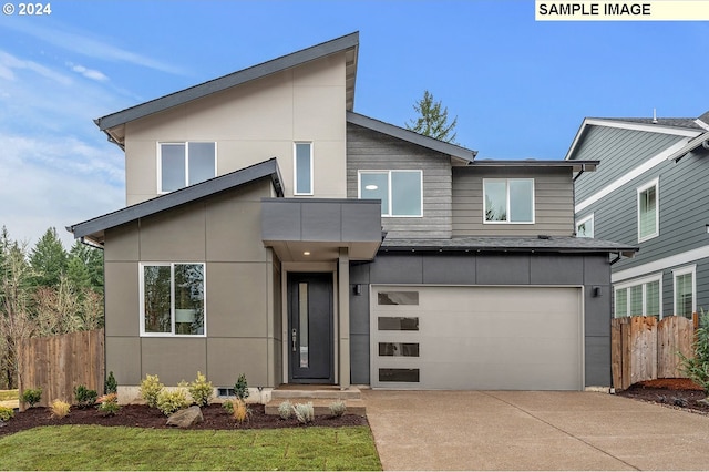 modern home featuring a front yard and a garage