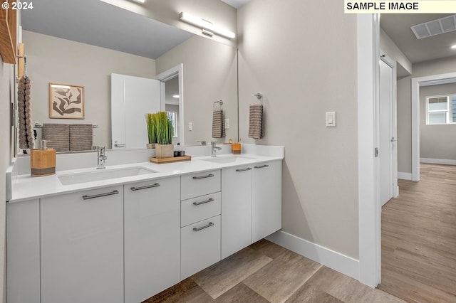 bathroom with vanity and hardwood / wood-style floors