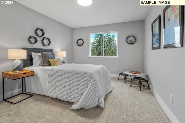 bedroom featuring light colored carpet