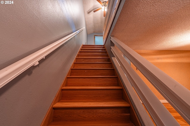 stairs with a textured ceiling