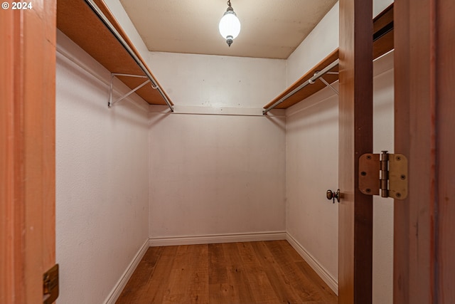 walk in closet featuring hardwood / wood-style flooring