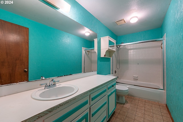 full bathroom featuring vanity, toilet, a textured ceiling, and bath / shower combo with glass door