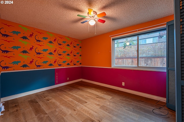 unfurnished room featuring ceiling fan, a textured ceiling, and hardwood / wood-style floors