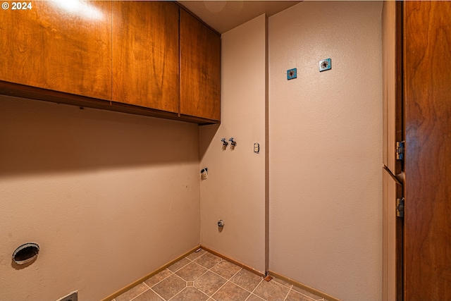 laundry area with light tile patterned flooring, gas dryer hookup, electric dryer hookup, washer hookup, and cabinets