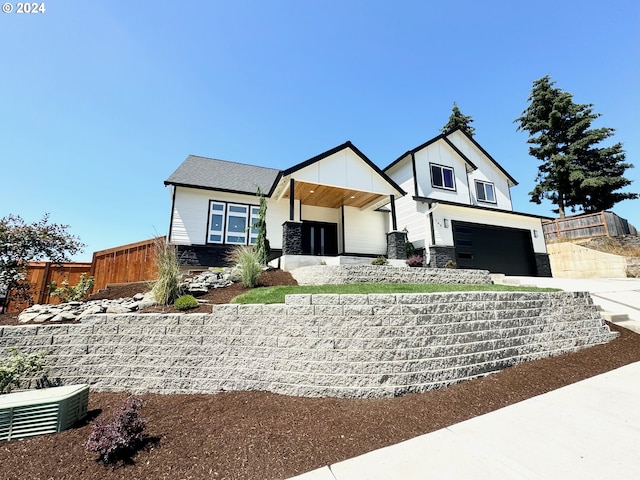 view of front facade featuring a garage and central AC