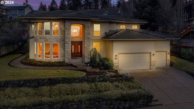 view of front of home featuring a garage and a lawn