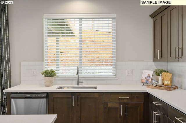 kitchen featuring tasteful backsplash, dark brown cabinets, sink, and stainless steel dishwasher