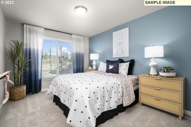 carpeted bedroom featuring a textured ceiling