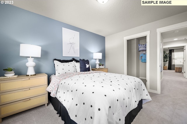 carpeted bedroom featuring a textured ceiling