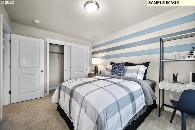 bedroom featuring a closet, a textured ceiling, and light colored carpet