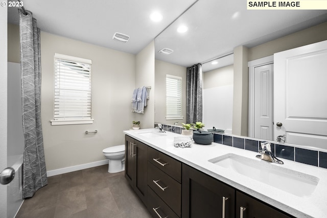 full bathroom featuring vanity, shower / tub combo with curtain, and toilet