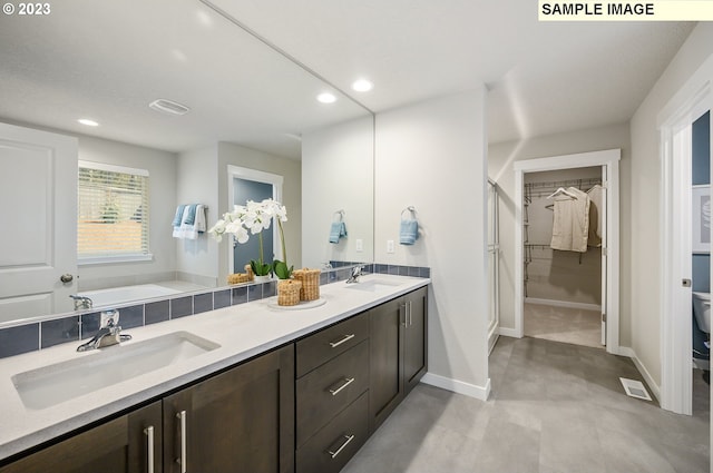 bathroom featuring vanity and a tub