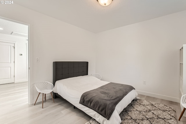 bedroom with light hardwood / wood-style floors