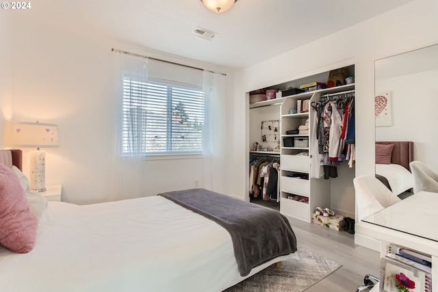 bedroom featuring a closet and light wood-type flooring