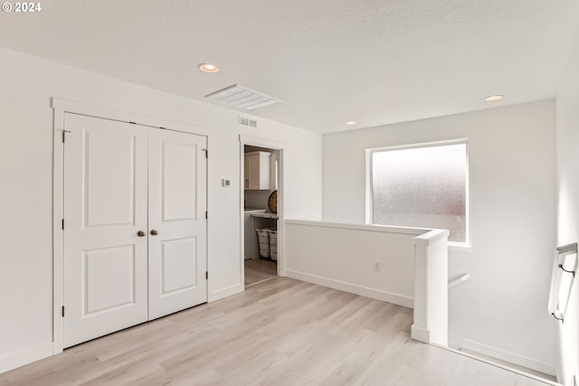 empty room with light hardwood / wood-style flooring