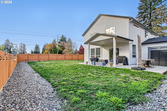 back of property featuring a patio and a lawn