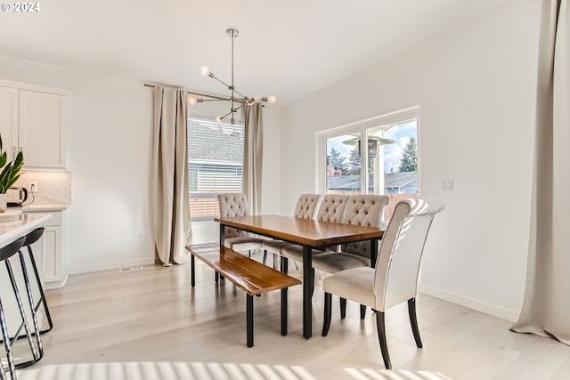 dining room with a chandelier and light hardwood / wood-style floors