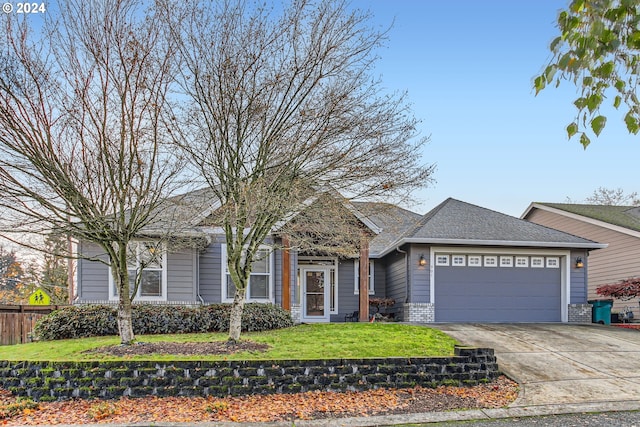 view of front of house with a garage and a front lawn