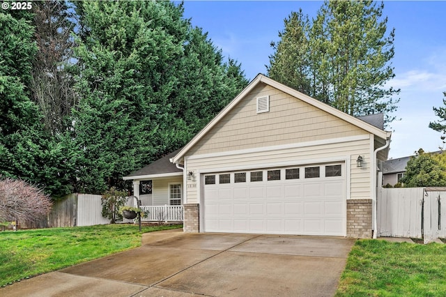 view of front of property featuring a porch, a front yard, and a garage