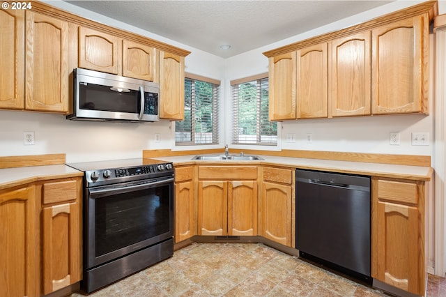 kitchen with appliances with stainless steel finishes and sink