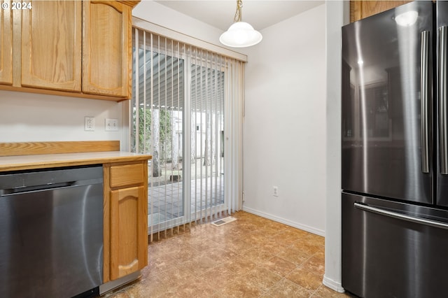 kitchen with stainless steel appliances and decorative light fixtures