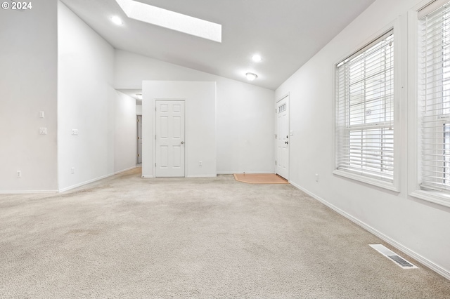 carpeted spare room featuring lofted ceiling