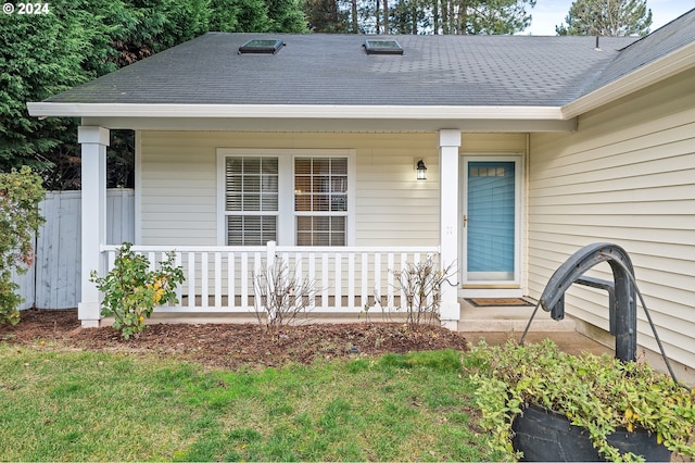 view of exterior entry with covered porch