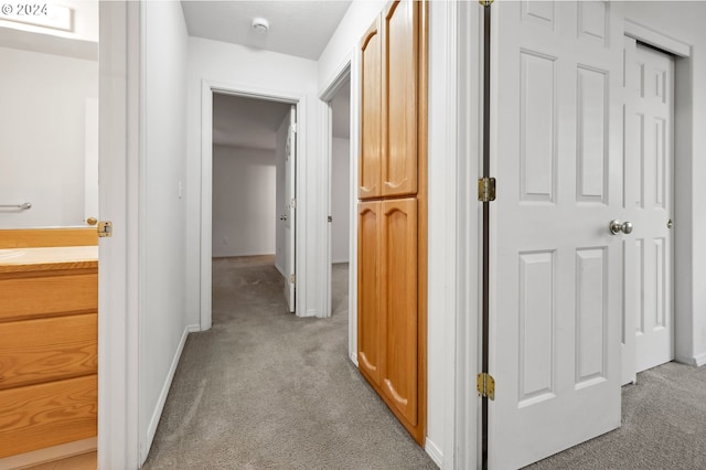 hallway featuring light carpet