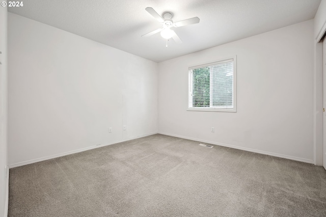 empty room with carpet floors and ceiling fan