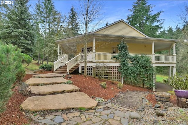 view of front of property featuring covered porch and stairway