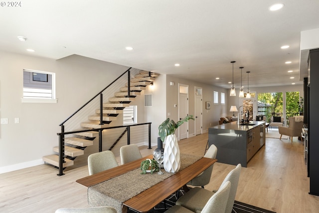 dining area with sink and light hardwood / wood-style flooring