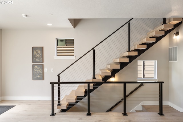 staircase featuring light hardwood / wood-style floors