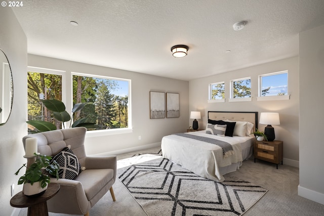 carpeted bedroom featuring a textured ceiling