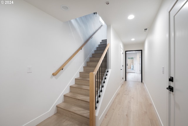 staircase with light hardwood / wood-style flooring