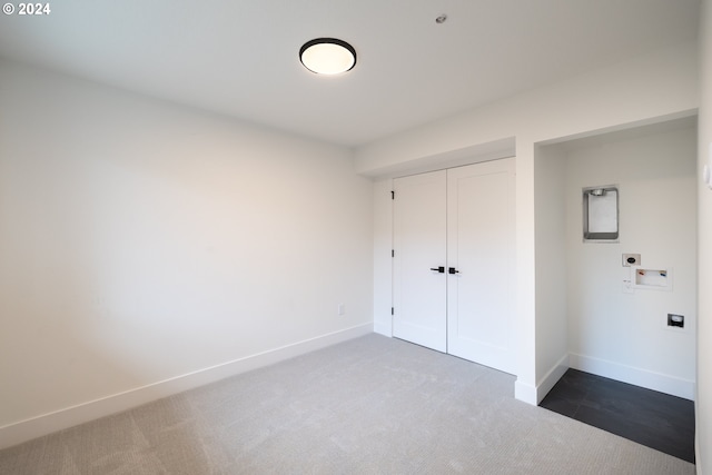 unfurnished bedroom featuring a closet and dark carpet