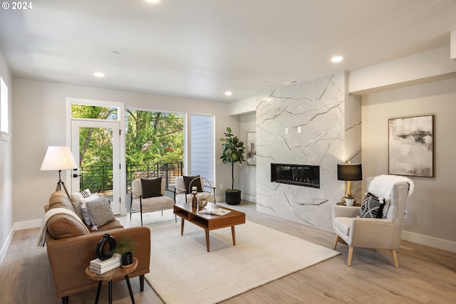 living room with hardwood / wood-style flooring and a high end fireplace